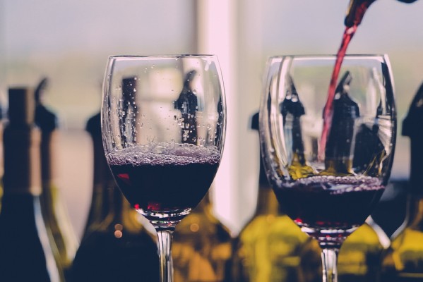 Pouring red wine in two wine glasses