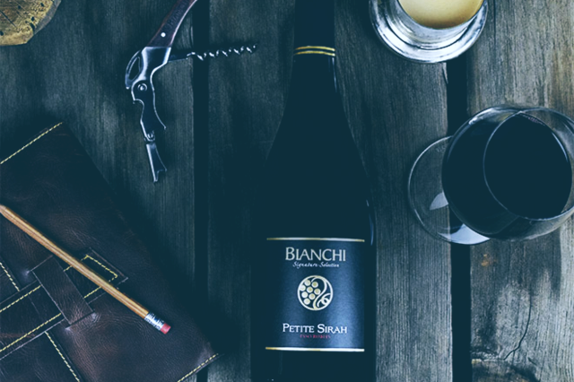 Bianchi Winery Paso Robles Wine on Table with Notebook and Corkscrew