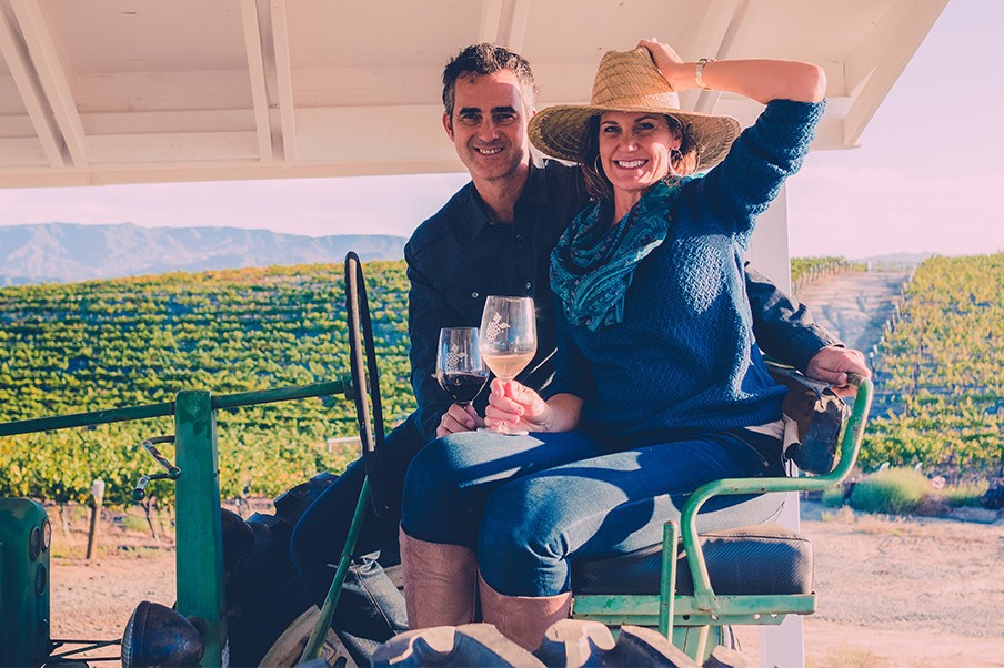 Couple on a tractor tasting wine