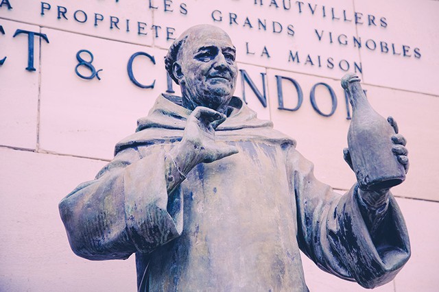 Statue of the monk Dom Perignon holding a bottle of champagne