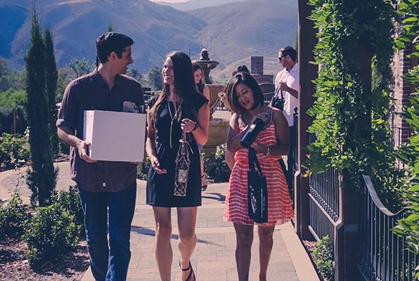 Young people walking out of winery with purchases