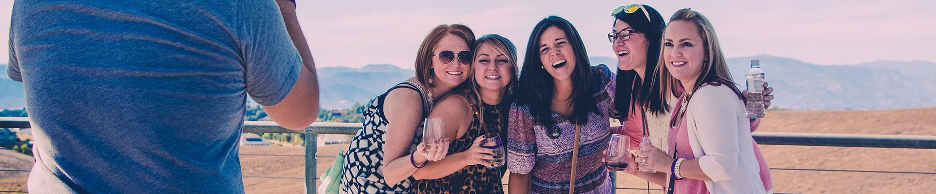 Five ladies taking photo with wine glasses
