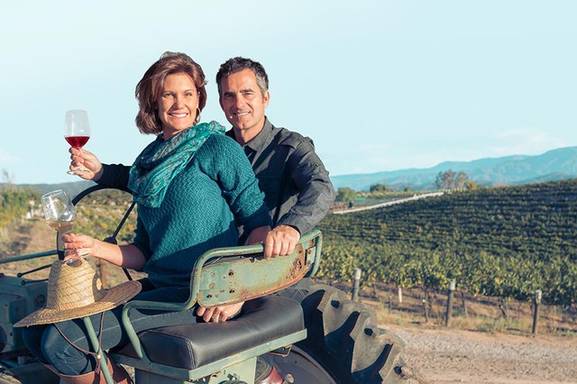 A couple sitting on a tractor at Palumbo Family Winery in Temecula Valley