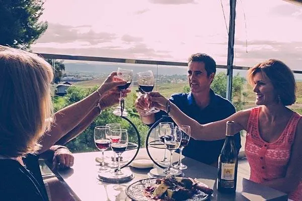 Two couples dining at a winery