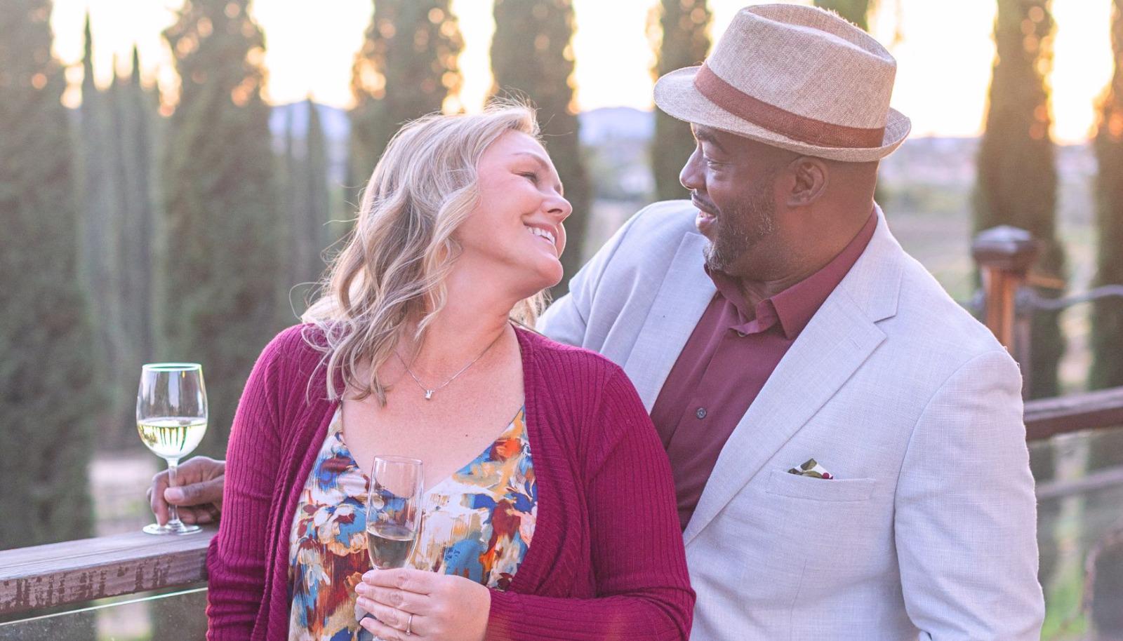 A couple toasting with wine glasses together