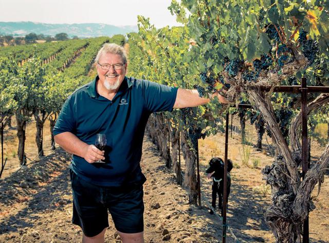 Gary Eberle in his vineyards holding a glass of red wine in Paso Robles