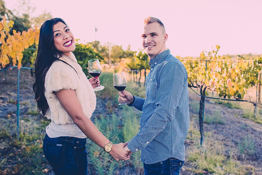 Couple holding hands in Paso Robles vineyard