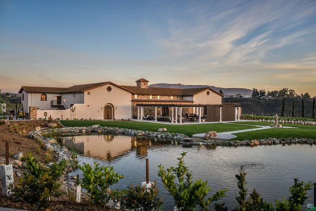 Avensole Winery with a pond and the glow of a beautiful sunset behind