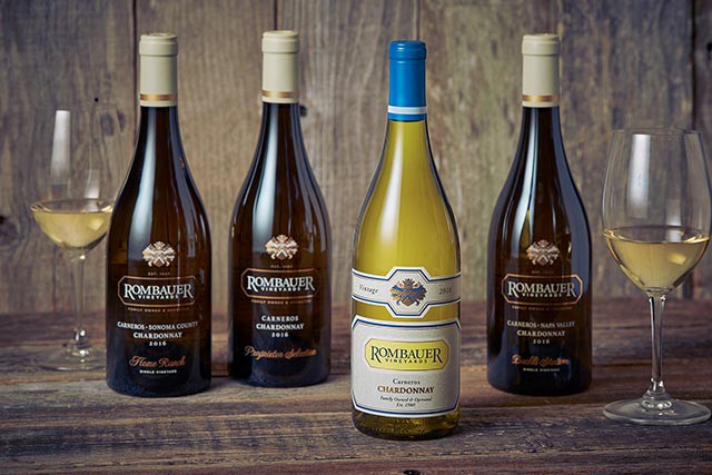 Several bottles of Napa's Rombauer Chardonnay with glasses of wine ready to taste